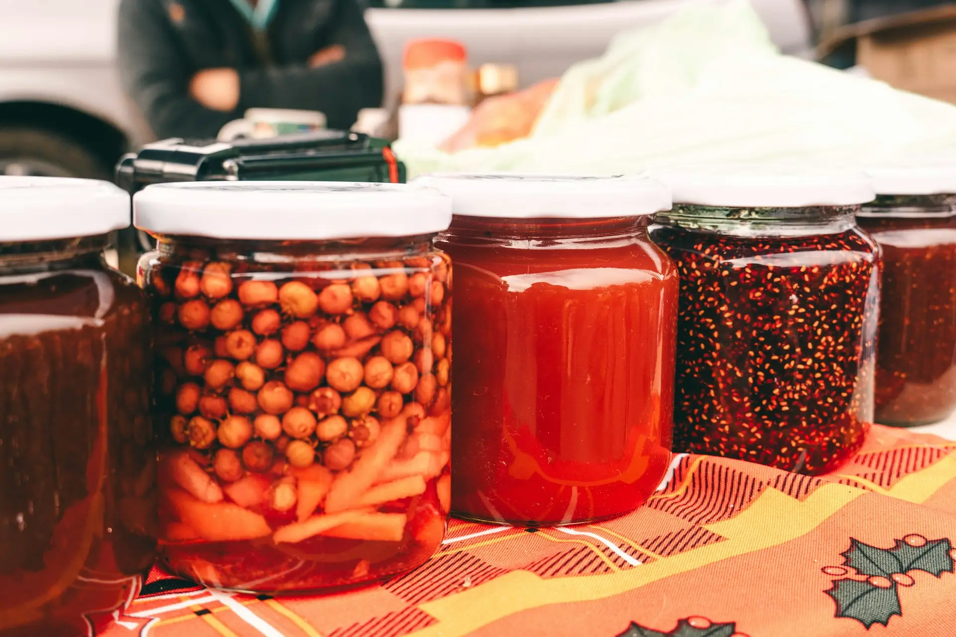 a table topped with jars filled with different types of food